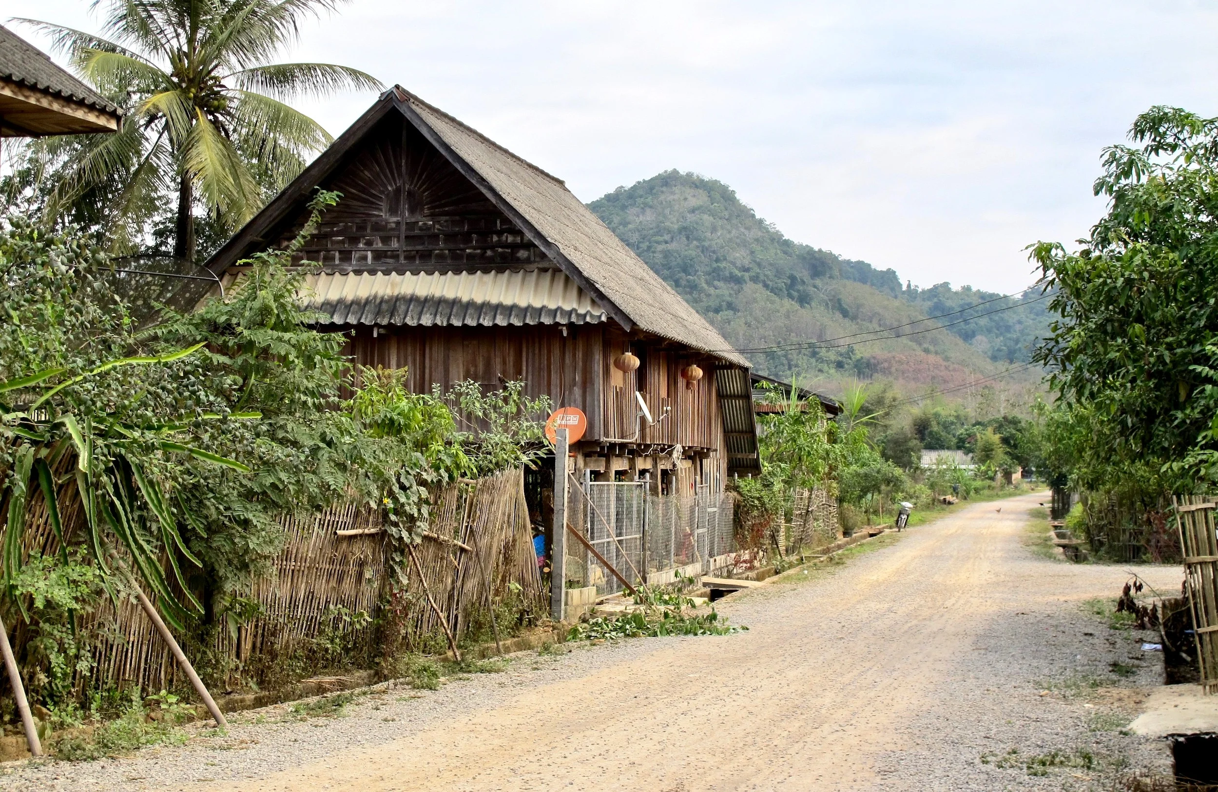 Nayang Nua today – 180 families enjoy electricity, better roads, satellite dishes, scooters, smartphones, a weekly market, and running water into homes.