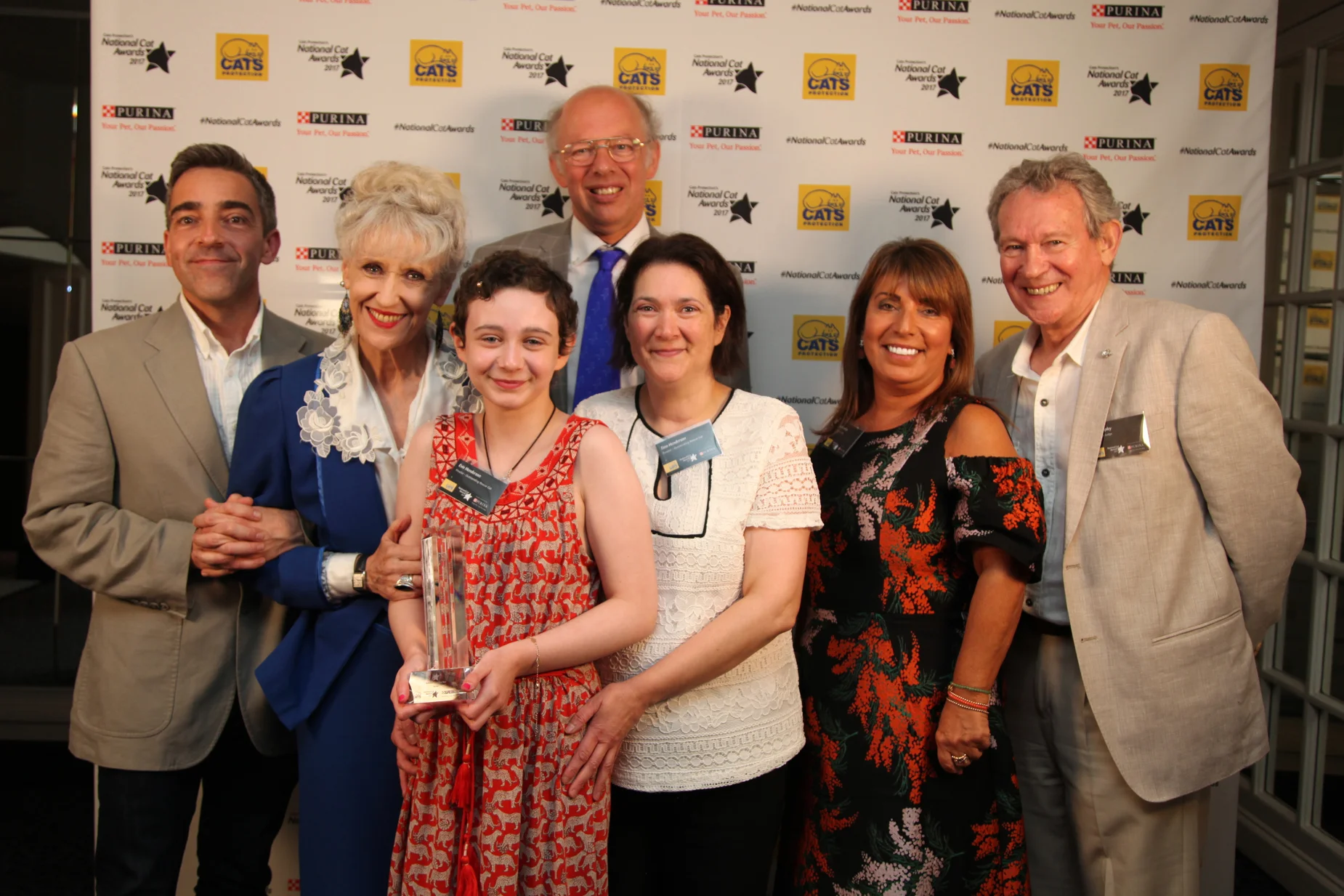 12 year old Evie, centre, with mum Tina, in white, and some of the celebrity judges who presented the award to her