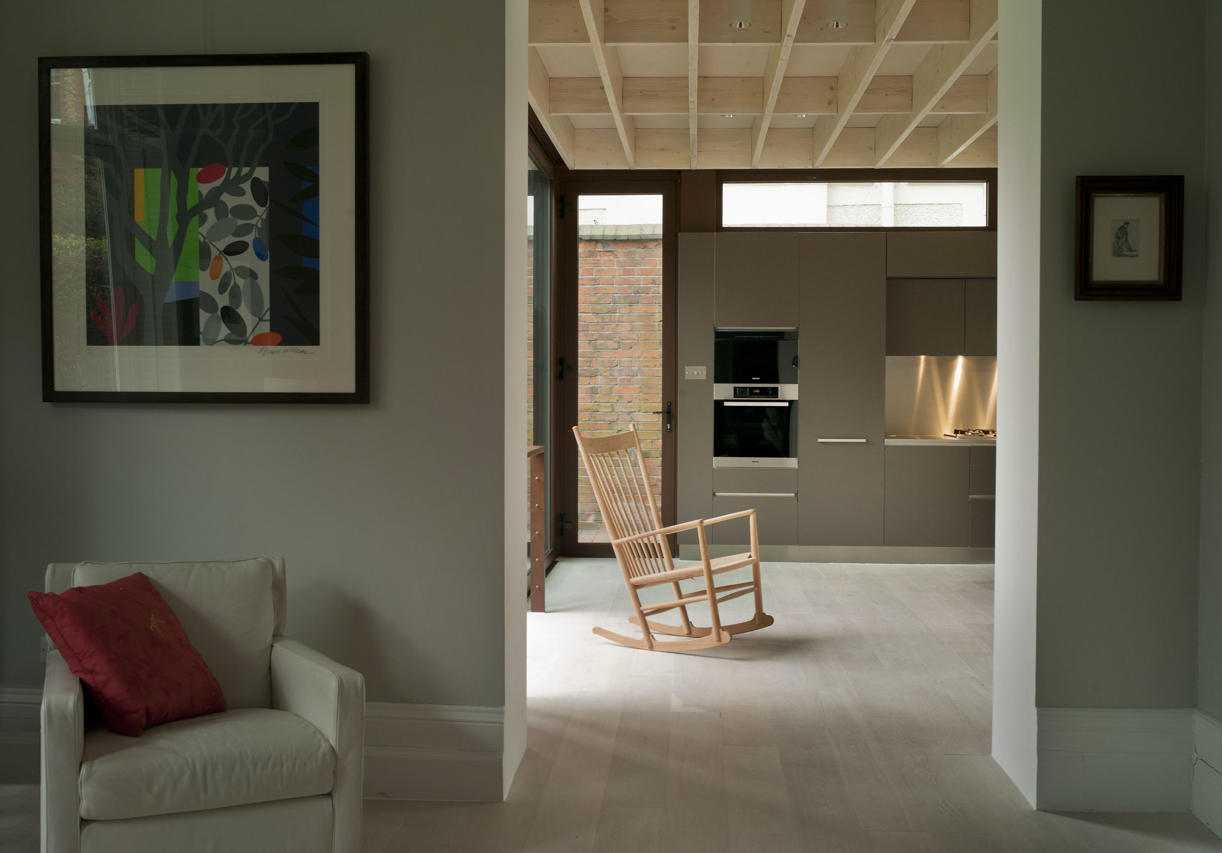 The timber joists of the ceiling are planed and left exposed - aiding acoustics and adding textural interest.