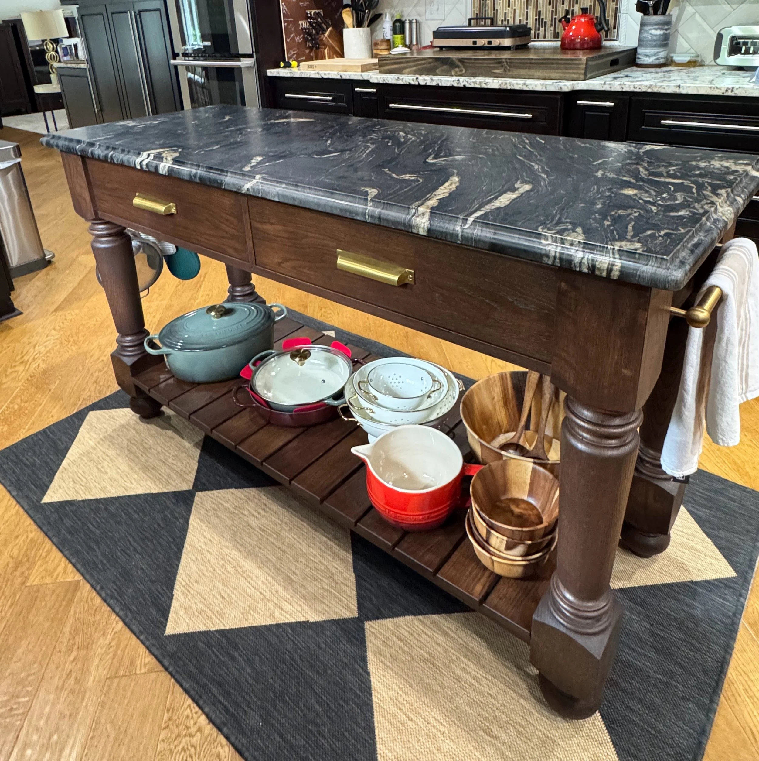 A white oak kitchen island with a custom marble top. 