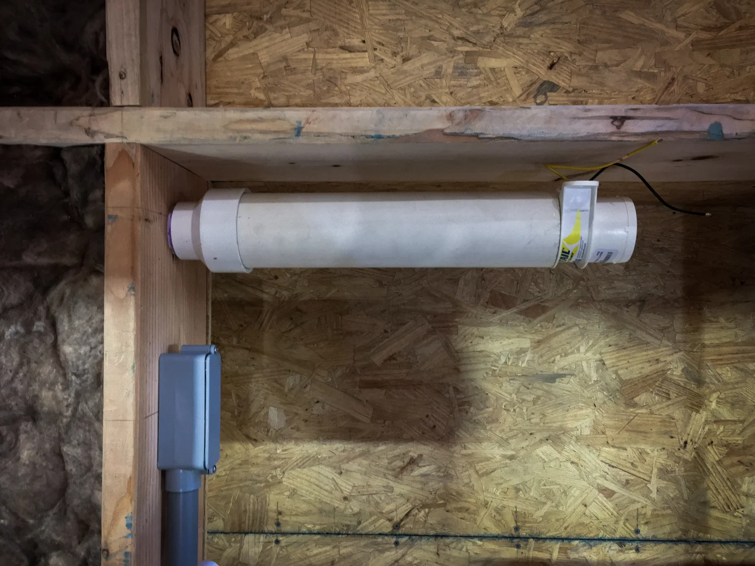 White tube: fan and air vent for solar electric battery bank. Grey box: electrical hookup to battery bank from charge controller.