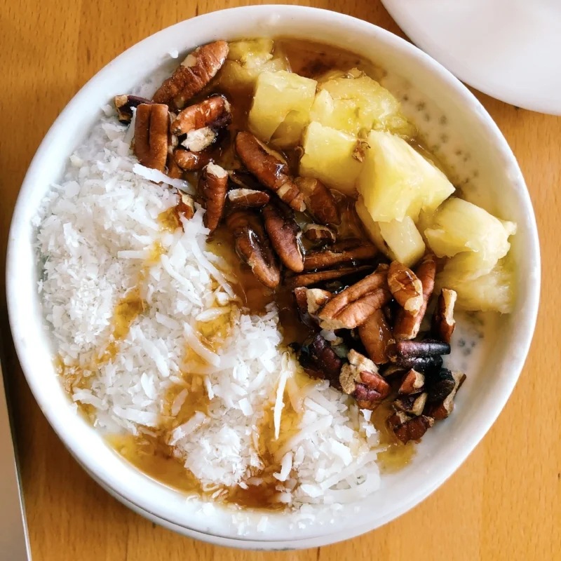 The coconut chia pudding bowl at The Green Corner with pineapple, pecans, shredded coconut and maple syrup