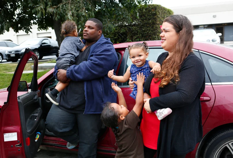Ashante and Jennifer Parker and kids Amarion, 2, Tristen, 4, and one-year-old, Aria, take a break from living in their car in Gilroy, Calif., on Monday, August 14, 2017. Jennifer and Ashante Parker couldn't make rent on their Modesto apartment after Ashante suffered an injury to his back and have lived out of the car for the past few months. (Gary Reyes/ Bay Area News Group)