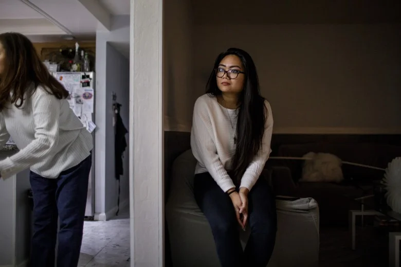 Jessica Page, center, spends an evening with her aunt, Gen Page, left, on Dec. 21, 2017 in their Milpitas home. Jessica Page shares a house in Milpitas with four relatives and wonders if she will be able to afford her own apartment in the coming years. A college graduate and fully employed, she is saving up for graduate school, but feels “stuck” in her living situation because of the high cost of Bay Area housing. (Dai Sugano/Bay Area News Group) 