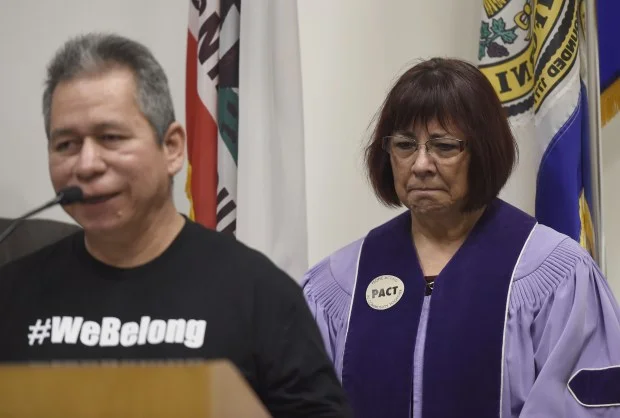 Liliana Devalle, pastor at Grace Baptist Church, listens as Ernesto Perez spoke this month at a news conference at San Jose City Hall, where city officials, local community leaders and members of People Acting in Community Together (PACT) discussed the resources and services available to undocumented immigrants amid rumors of impending ICE raids. (Dan Honda/Bay Area News Group) 