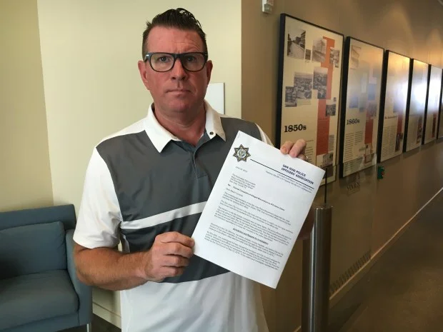 Sgt. Paul Kelly, president of the San Jose Police Officers’ Association, holds up a letter that calls for the investigation and removal of Independent Police Auditor Aaron Zisser over alleged ethics violations in an annual audit report, at San Jose City Hall on June 25, 2018. (Robert Salonga/Bay Area News Group) 