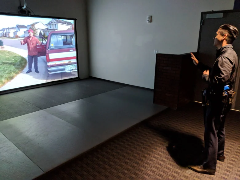 Assemblyman Evan Low, D-Campbell, interacts with the San Jose Police Department's force-option simulator at the SJPD substation in South San Jose on Aug. 17, 2018. (Robert Salonga/Bay Area News Group)
