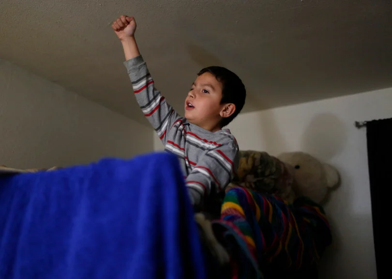 Mountain View, CA - DECEMBER 4: Johnatan Flores Carrillo, 5, sings in his bedroom of his families apartment on W. Middlefield Rd. in Mountain View, Calif., on Tuesday, Dec. 4, 2018. Mountain View city officials are considering a developer's proposal to raze 20 rent-controlled, affordable apartments and replace them with 15 new, luxury town houses. (Nhat V. Meyer/Bay Area News Group)