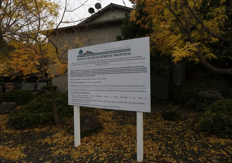 Mountain View, CA – DECEMBER 3: A sign announces a redevelopment proposal outside of the rent controlled apartment building along Rock St. in Mountain View, Calif., on Monday, Dec. 3, 2018. Mountain View city officials are considering a developer’s proposal to raze 20 rent-controlled, affordable apartments and replace them with 15 new, luxury town houses. (Nhat V. Meyer/Bay Area News Group)