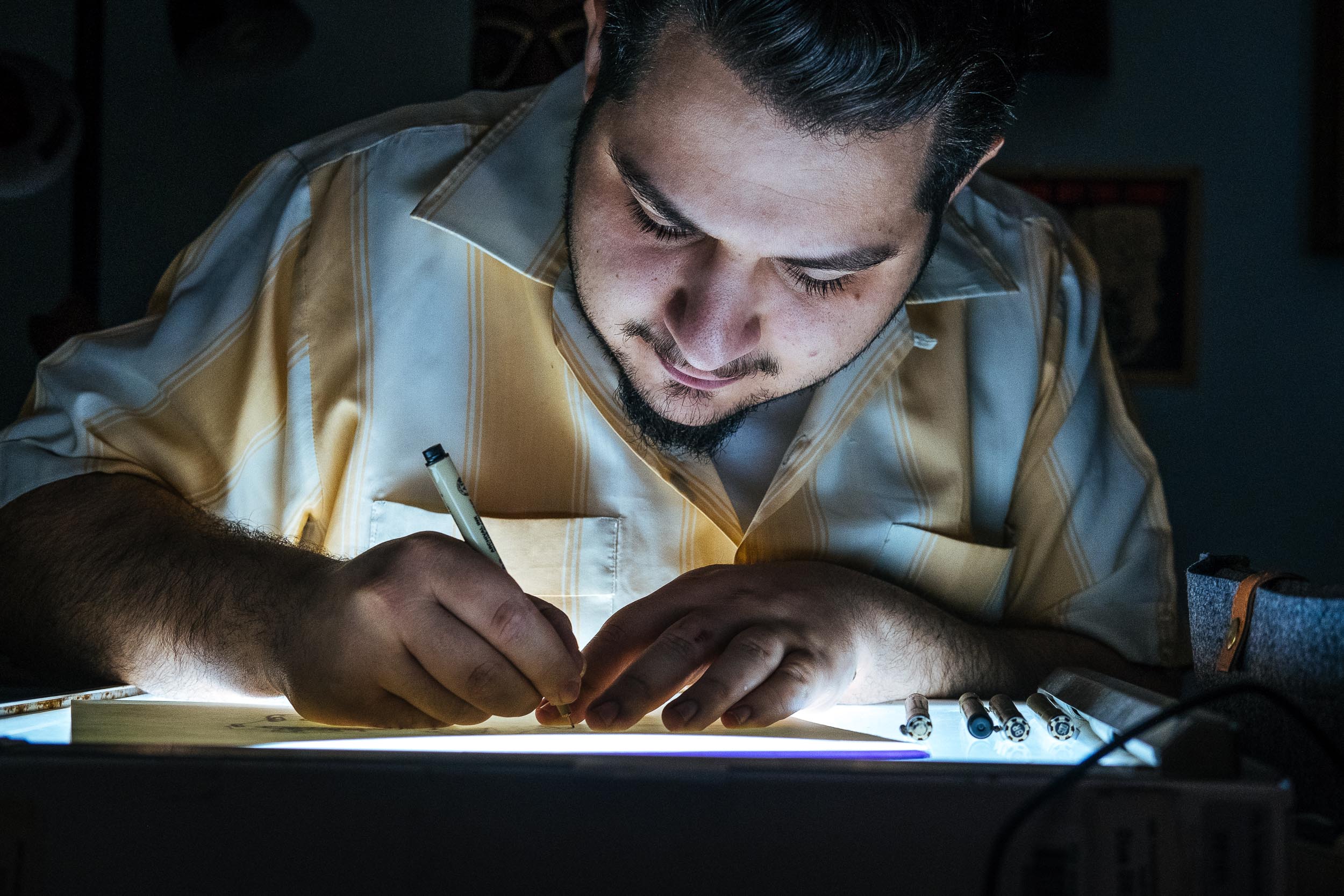 Johnny works on a cartoon in his studio. 