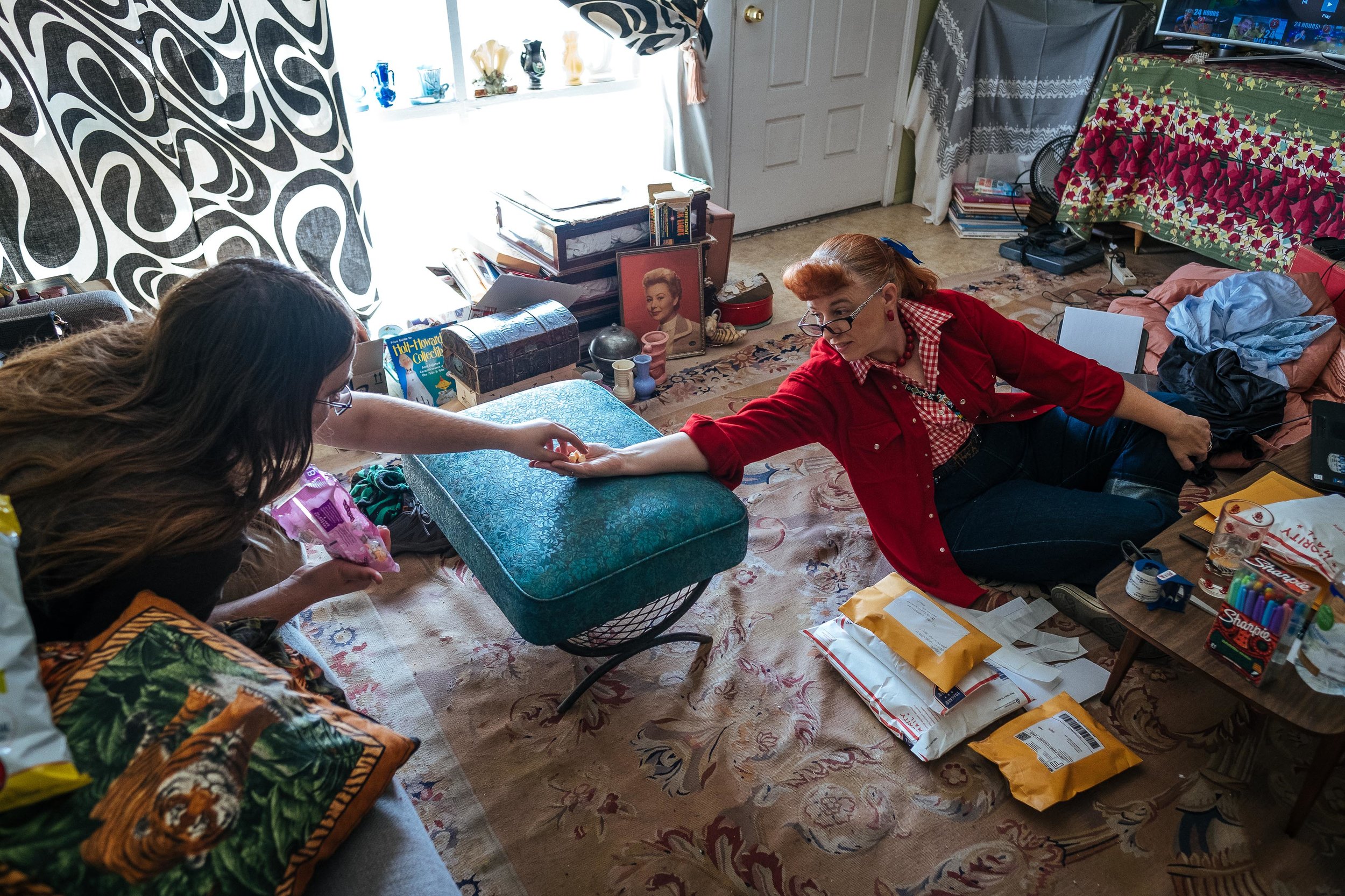 Jenny's son, Zefram, 18, shares some candy in theliving room. Jenny also has a 30 year old daughter, LeCresia, who lives in Montana. 