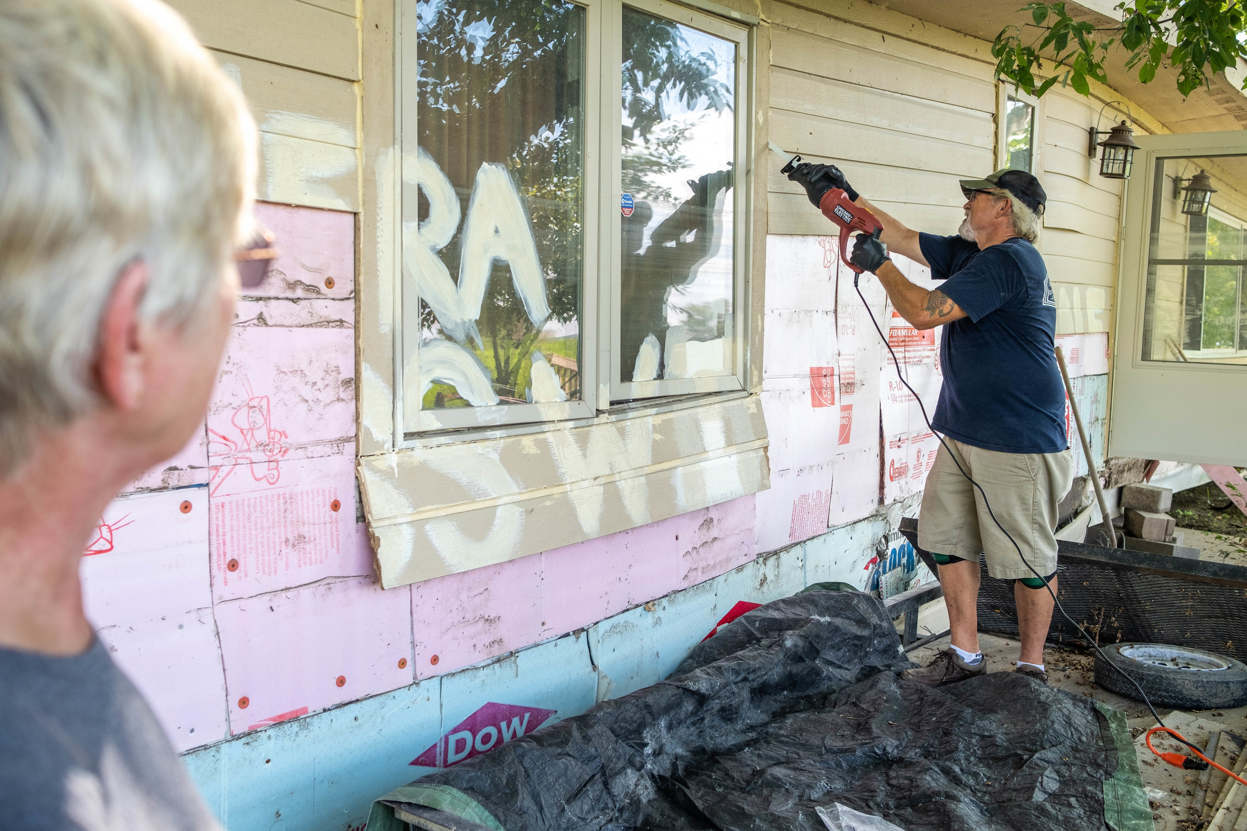  Dean cuts out a window on the front of the home in order to access the family room. 