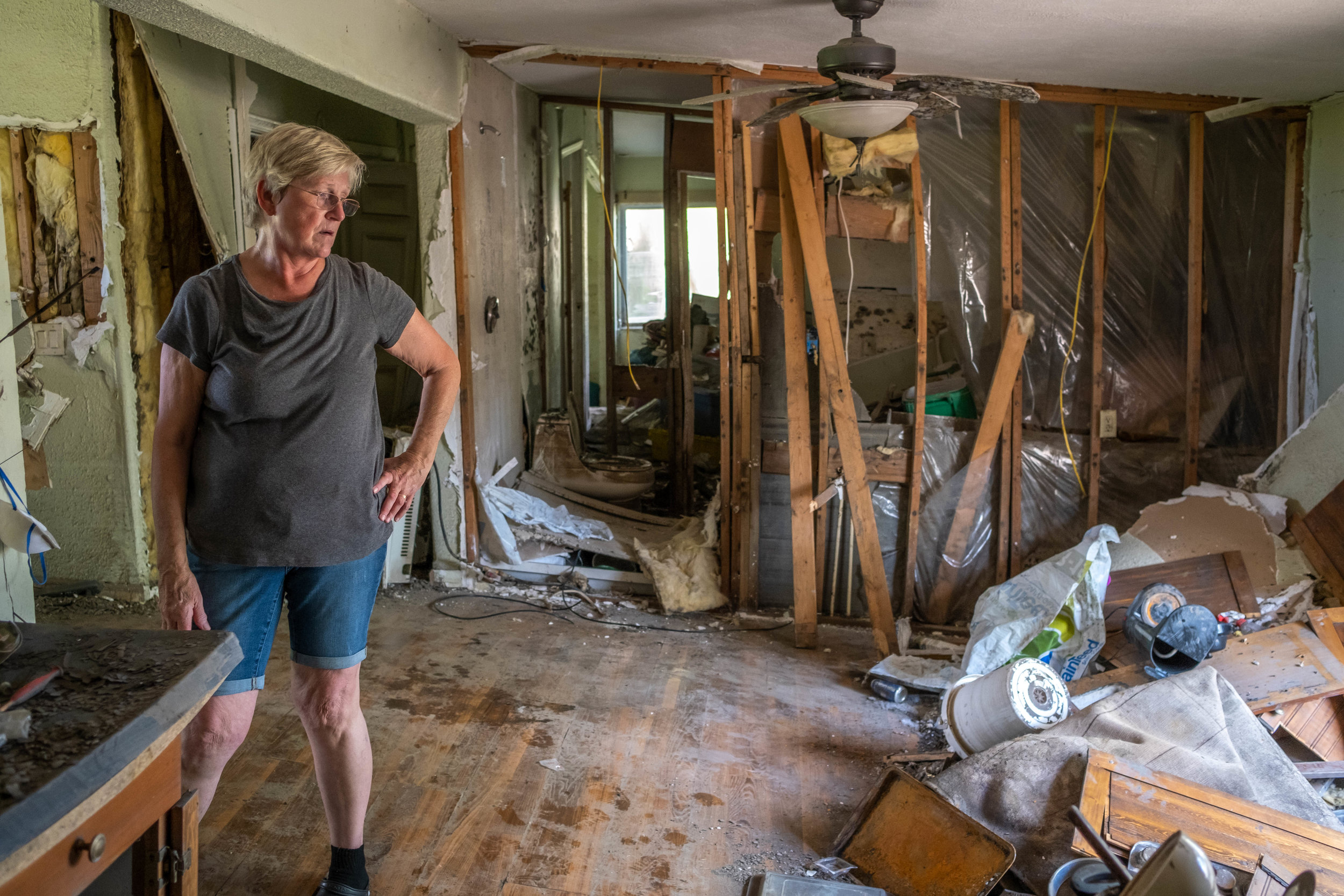  Carol Doty takes a moment to assess the damage. Despite the flood occuring several months back, Carol has only been inside a few times. She's lived in Bartlett since she was 3 years old, and said it's very difficult coming back to all the damage. 