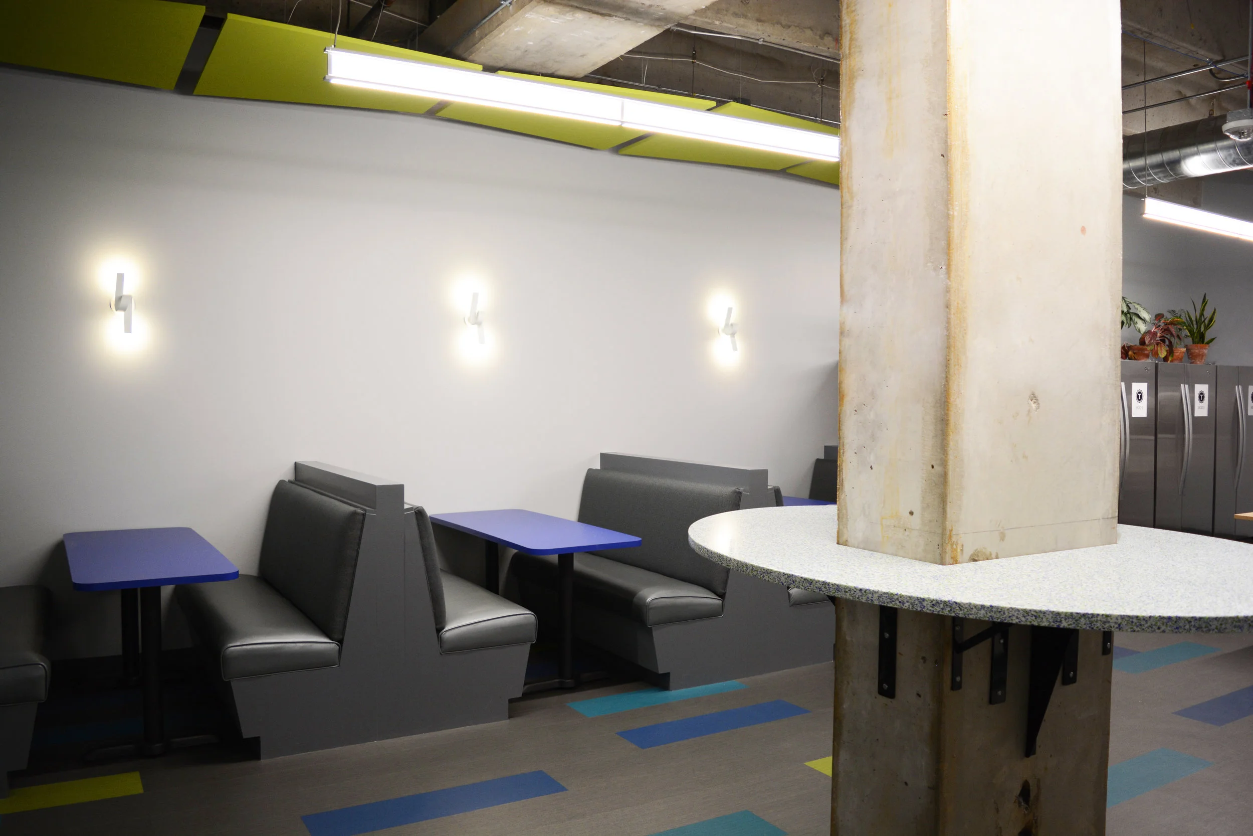 Turing is not the typical higher education campus but that didn’t deter us from providing some campus style. The break room includes built-in banquettes and recycled glass countertops that enhance the bright color palette of the space by utilizing green and blue glass chips.
