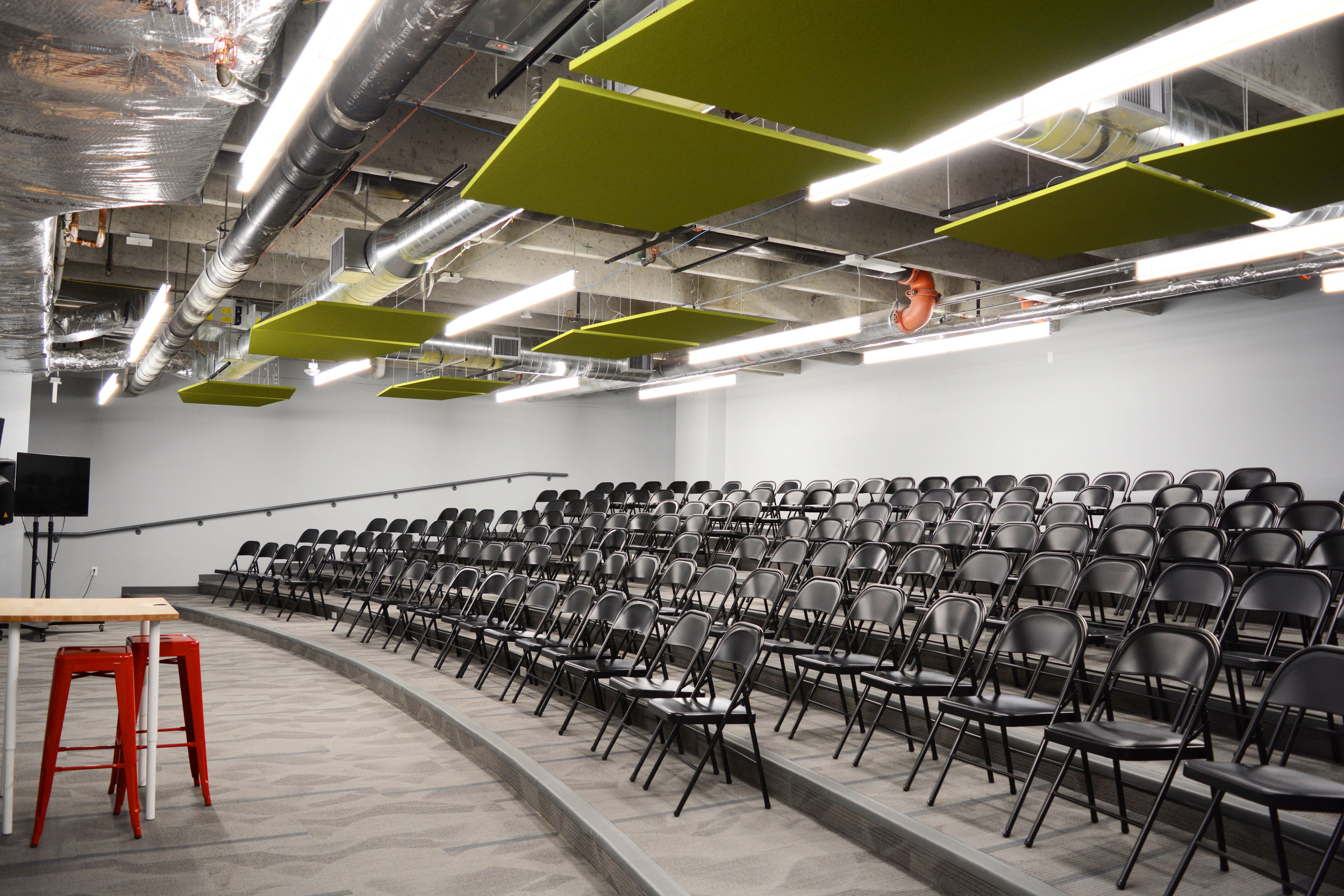 At times, larger lectures are scheduled for the school. Rather than pack in as many students as possible into a standard classroom, we created a room with tiered seating to house the larger crowds. When not in use as a lecture hall, students are able to work on projects with plenty of room for multiple groups in the room at one time; a truly multi-use space. Kestrel utilized the use of Armstrong SoundScapes Shapes to help keep noise levels down within the large, common areas.
