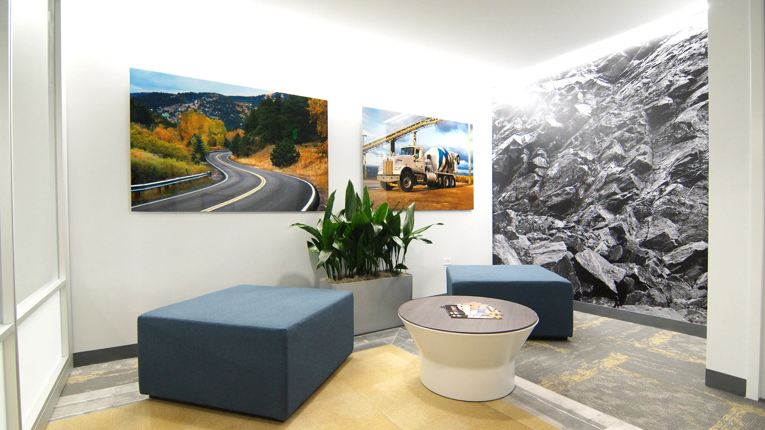 Kestrel’s utilization of custom and original imagery throughout the new space reflects the different aspects of Martin Marietta’s work was highly important to the client. This photo shows the public side of the reception area where a graphic printed by Wolf Gordon of a rock quarry along with photos printed on metal sheets are the focal point, along with a low seating arrangement, leaving the graphics in full view.
