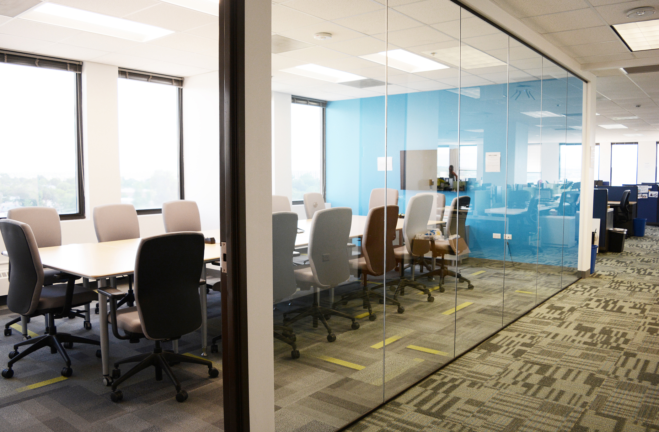 The large conference room, located along the south glass perimeter, utilizes salvaged glazing from the previous build-out to allow natural light into the space. Kestrel used two coordinating Patcraft carpet tiles to distinguish meeting space from open office.