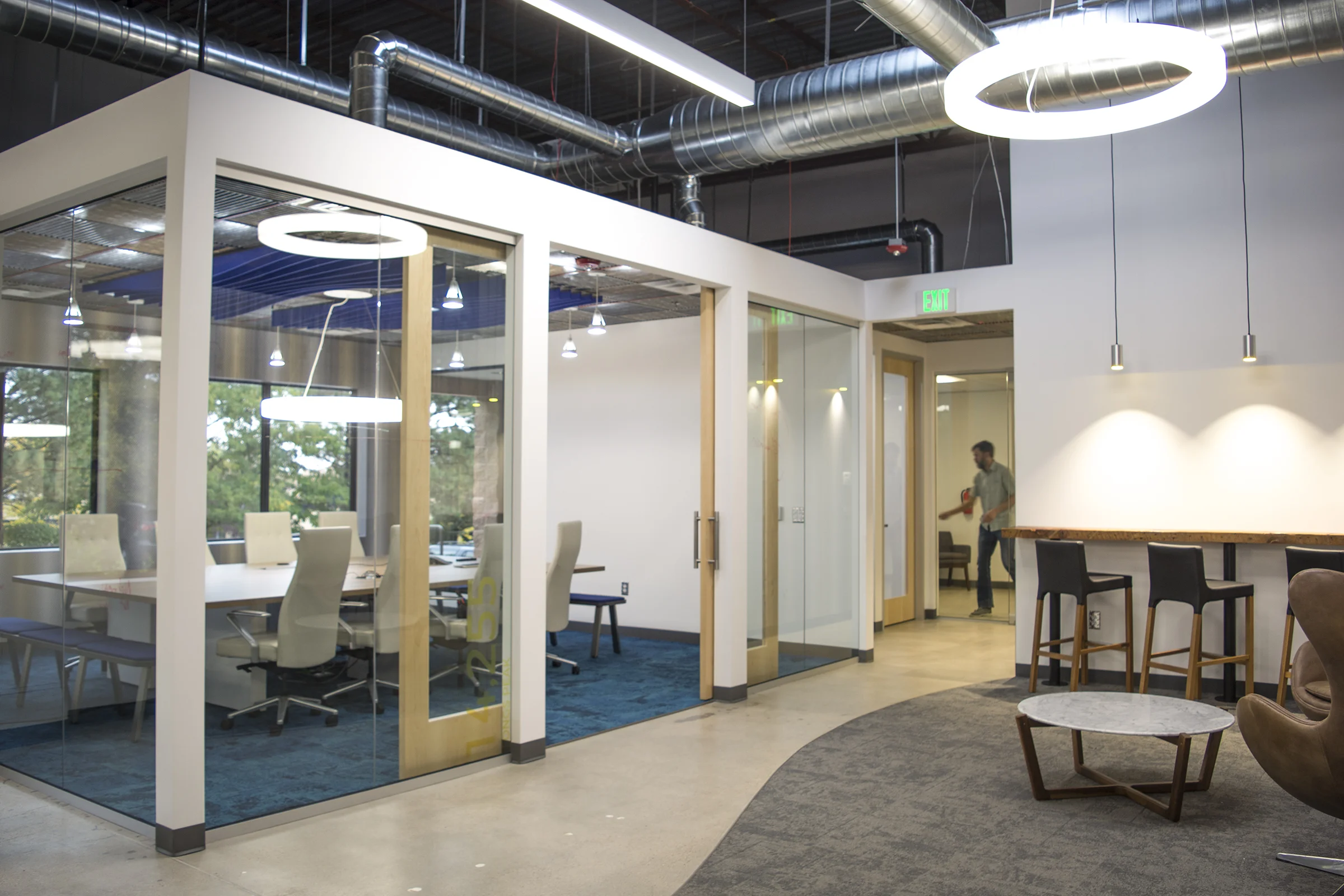 The boardroom, located just off the entry, is afforded a prime location on the glass while still maintaining privacy from the rest of the open office. The room repeats the curving Zintra blades that are found in the entry and Interface Net Effect carpet leads visitors through the space.