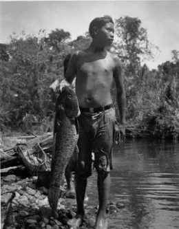 Boy holding “aimara” fish