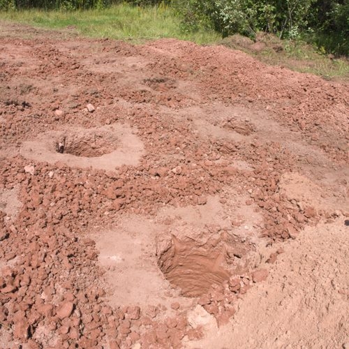 Holes were augured for a barn foundation,