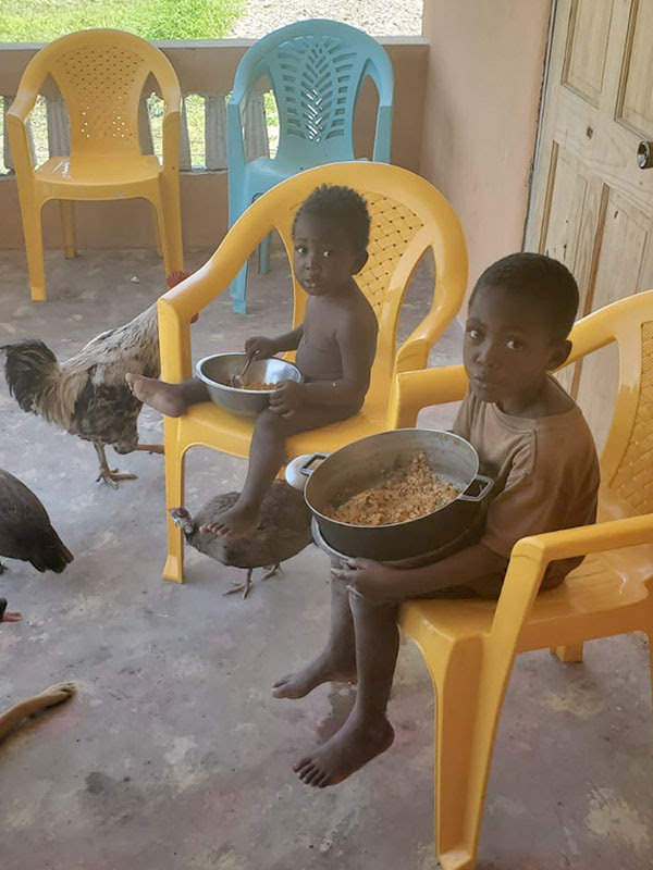 No more dirt floor for meals! - The boys are eating in new chairs, on new concrete floor.