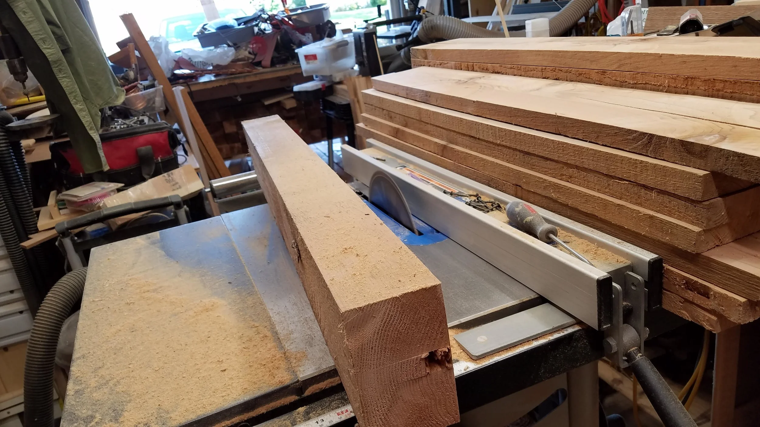 Ripping 6x6 cedar posts to 1x6 boards. After this, off to the thickness planer.