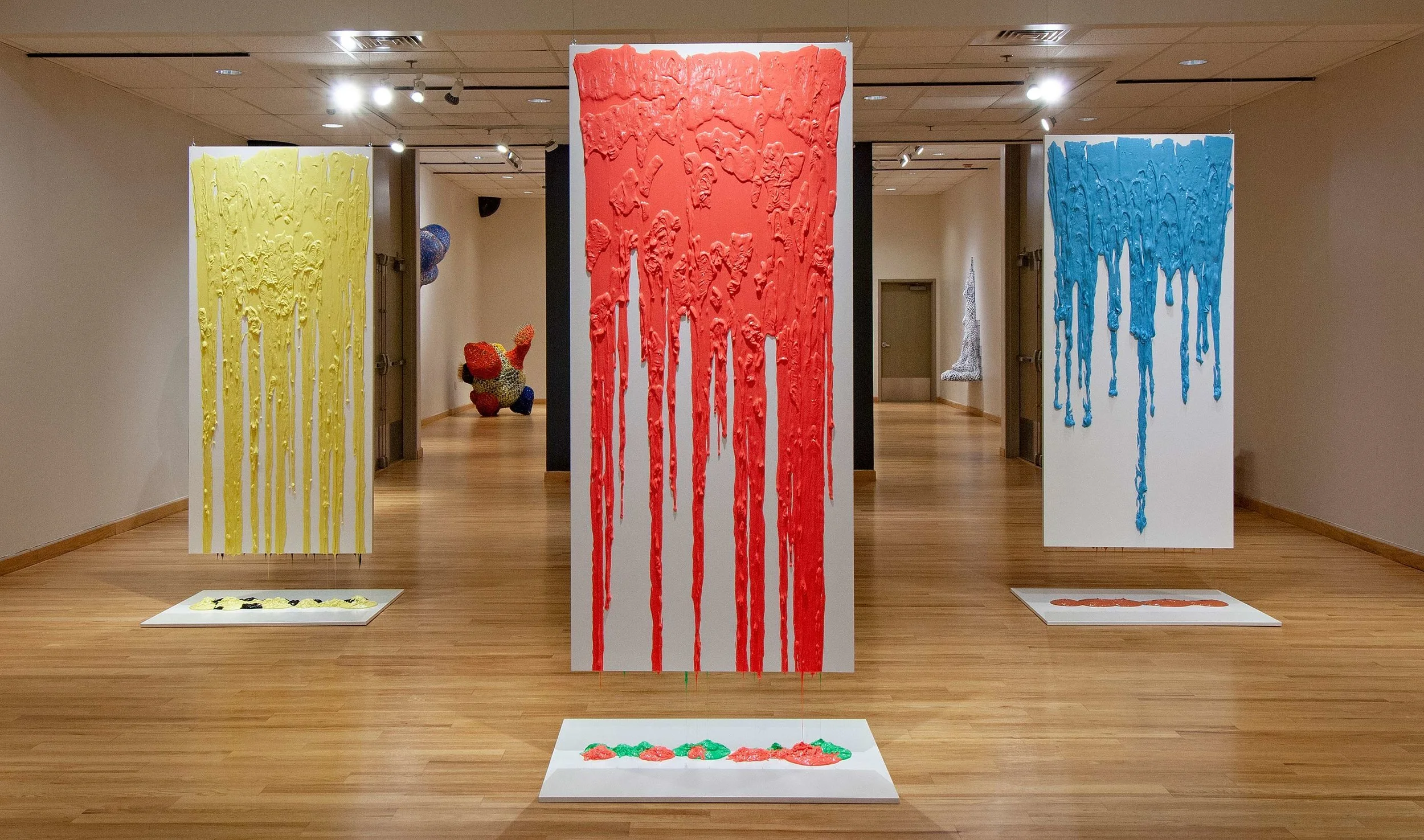 Putty Installation #2, Black, Yellow, Red, Green, Coral, Blue 2018 silicone putty and wood individual panels - 80 X 36 X 1.75”