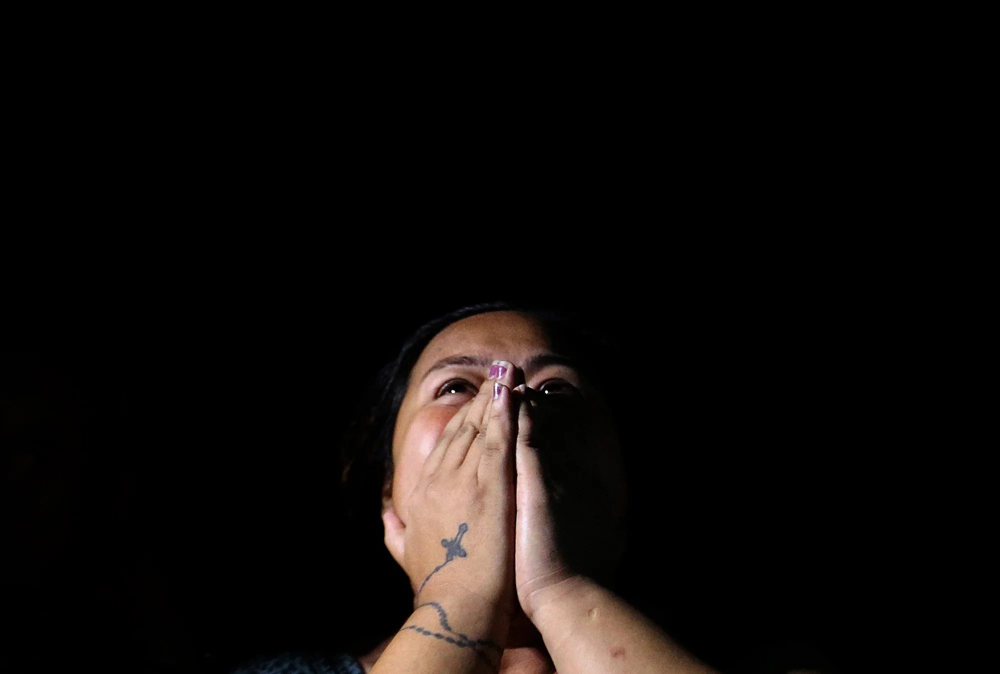 The sister of Jackie Flores alias "Chan-Chan" grieves after seeing the dead body of her brother who was shot to death by still-unidentified suspects along F.B Harrison Street and Libertad, Pasay on October 28, 2016. 