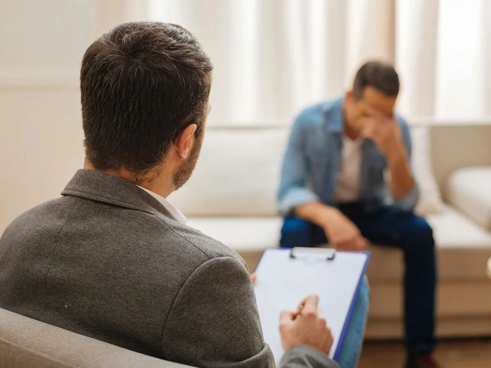 A therapist listening to a client
