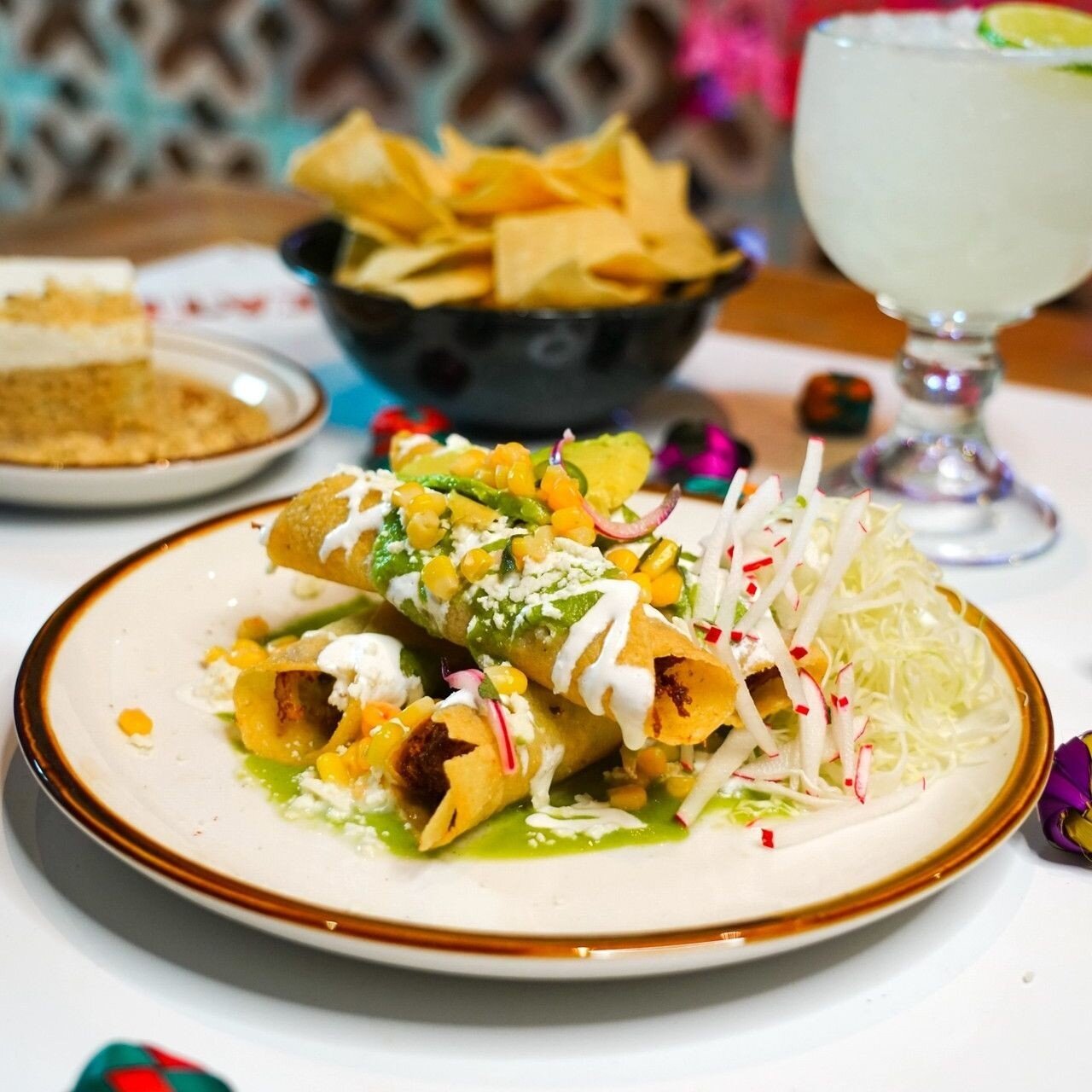 Our taquitos are a need, not a want. Filled with green chile chicken and topped with corn escabeche, avocado salsa, queso fresco and crema, you *need* to try these if you haven't already. 🌵⁠
⁠
📸: @mikahdanaephoto