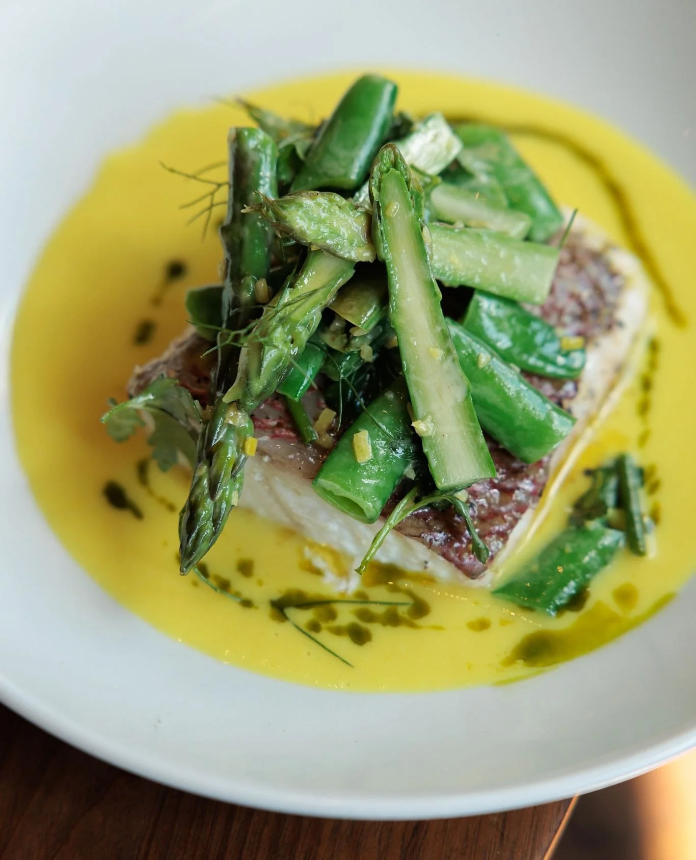 Gulf red snapper with asparagus, snap peas, herbs and fum&eacute;. Find your way here this weekend and give it a try.