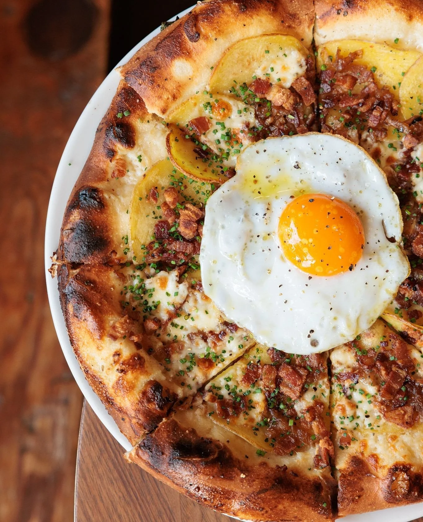 The Potato Pizza: creamy b&eacute;chamel, sweet Texas 1015 onions, gold potatoes, crescenza, Berkshire bacon, and a Three Sisters Farm (from Tomball, Tx) duck egg to finish.