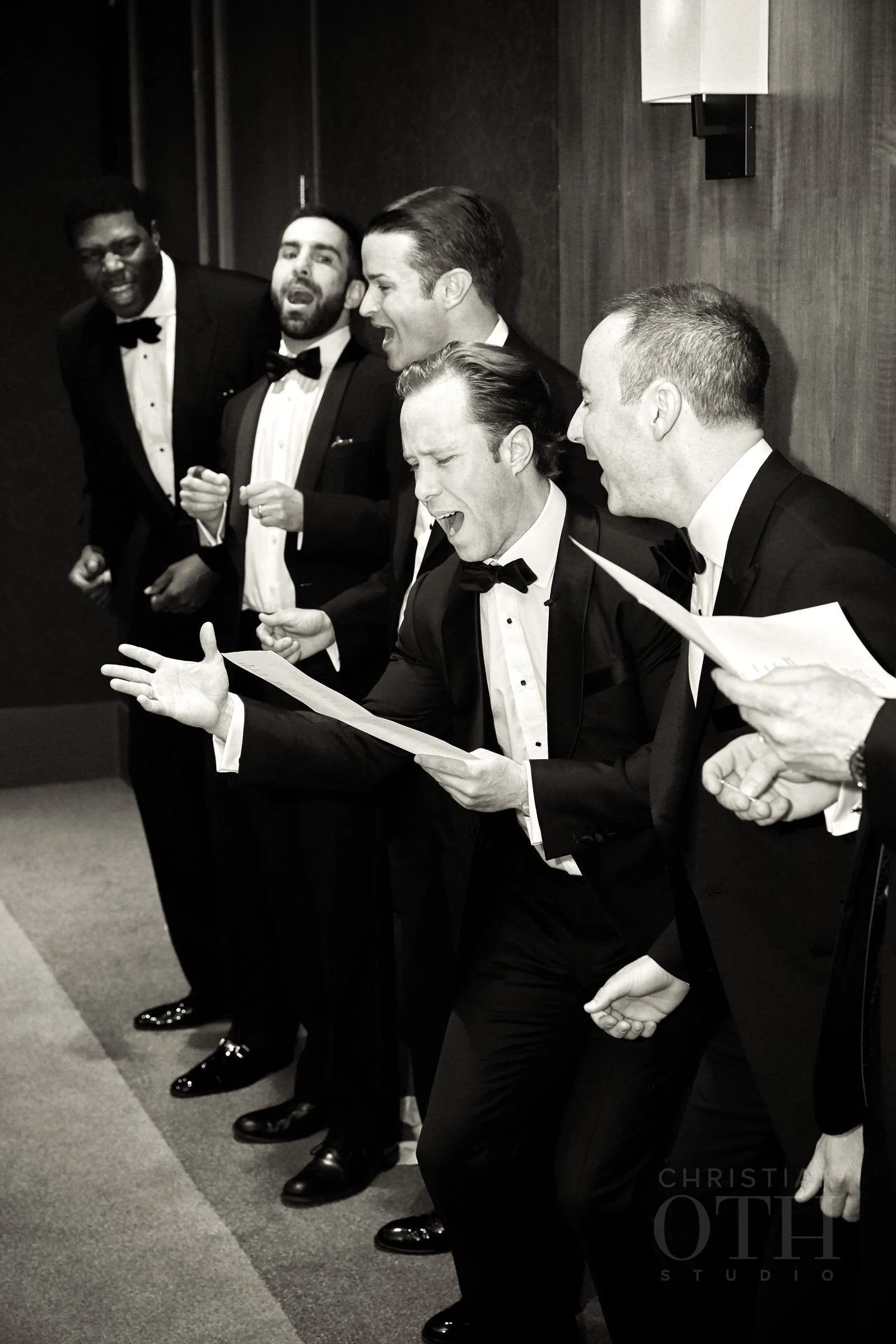 The groomsmen sang as part of the door games. Photo by Glen Allsop for Christian Oth Studio.