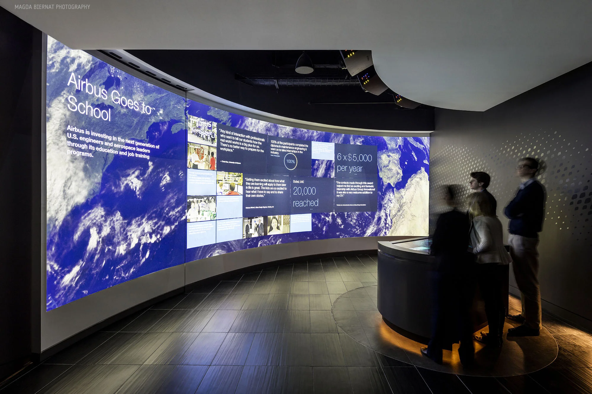 In the Briefing Room, a sweeping 30-foot wall stands in front of a touchscreen table where visitors can intuitively explore featured Airbus Group stories.
