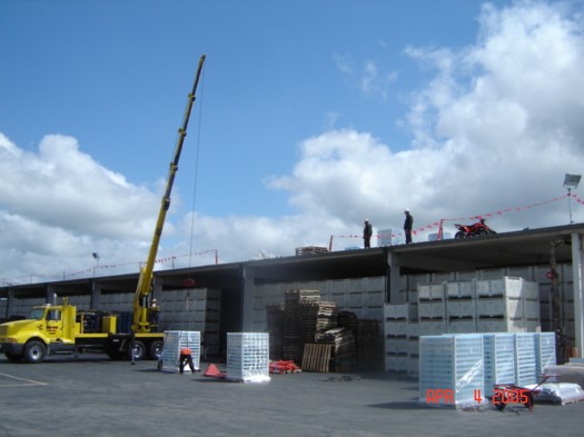 Crane lift onto metal building