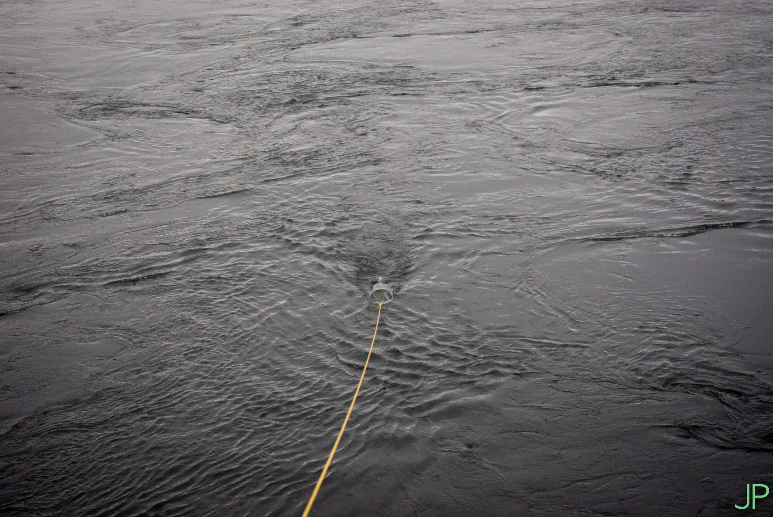 Sampling for microplastics involves towing a net in the river to filter capture the microplastics.