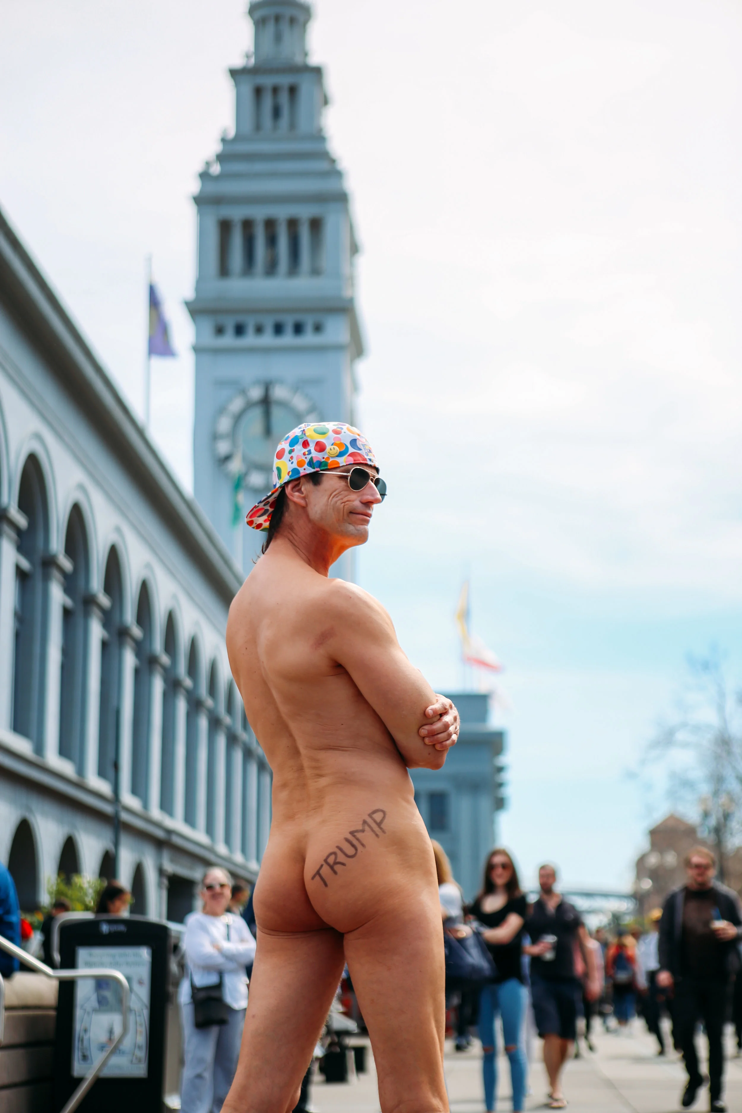 A person with Trump’s name written on their buttocks poses for a portrait in front of San Francisco’s Ferry Building.