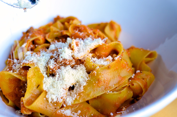 Pappardelle Bolognese with a bountiful amount of parmesan cheese.