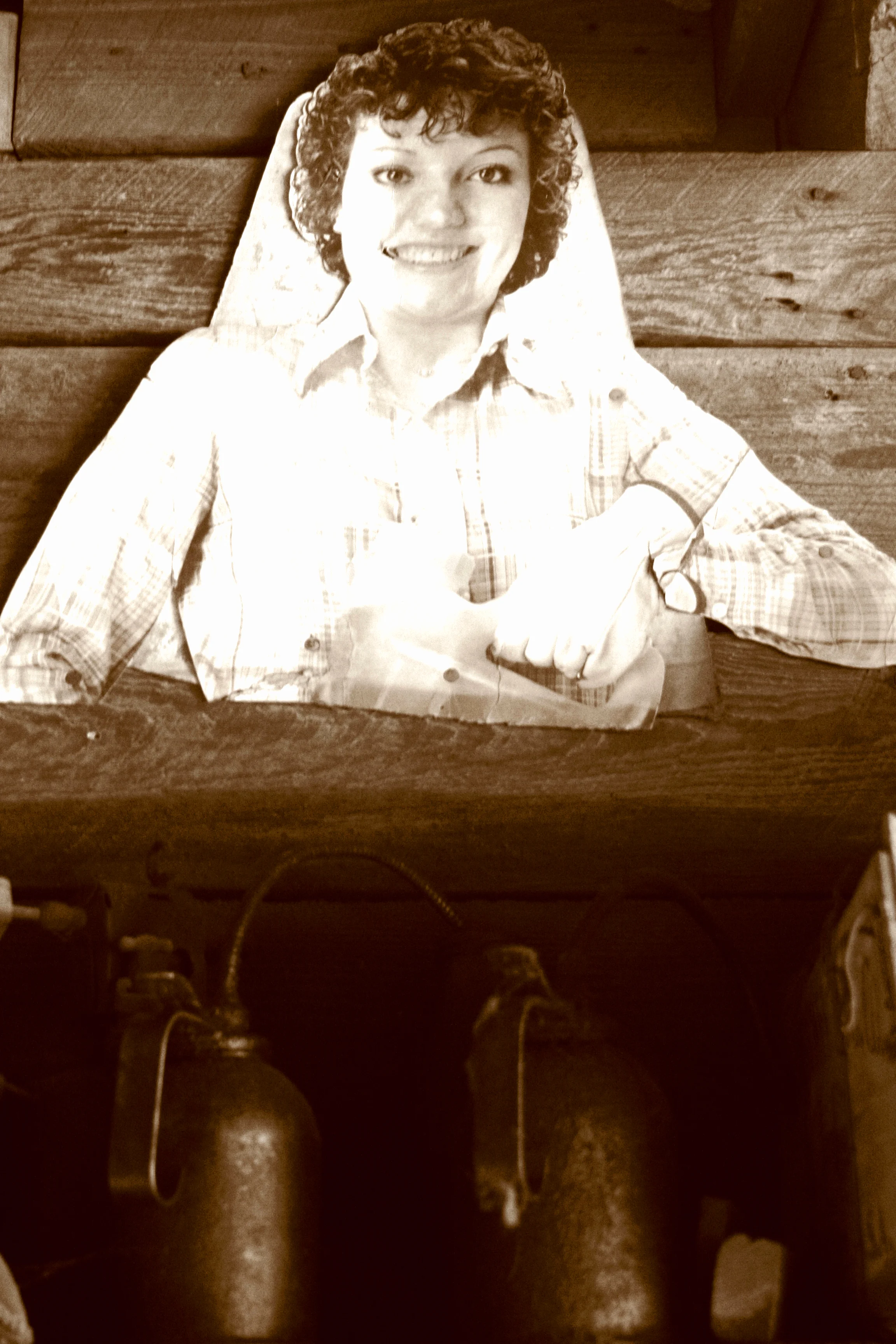 Cutout of a person, possibly from a tobacco advertisement, but holding an iron? Many of these cutouts decorate the inside of the tobacco barns.
