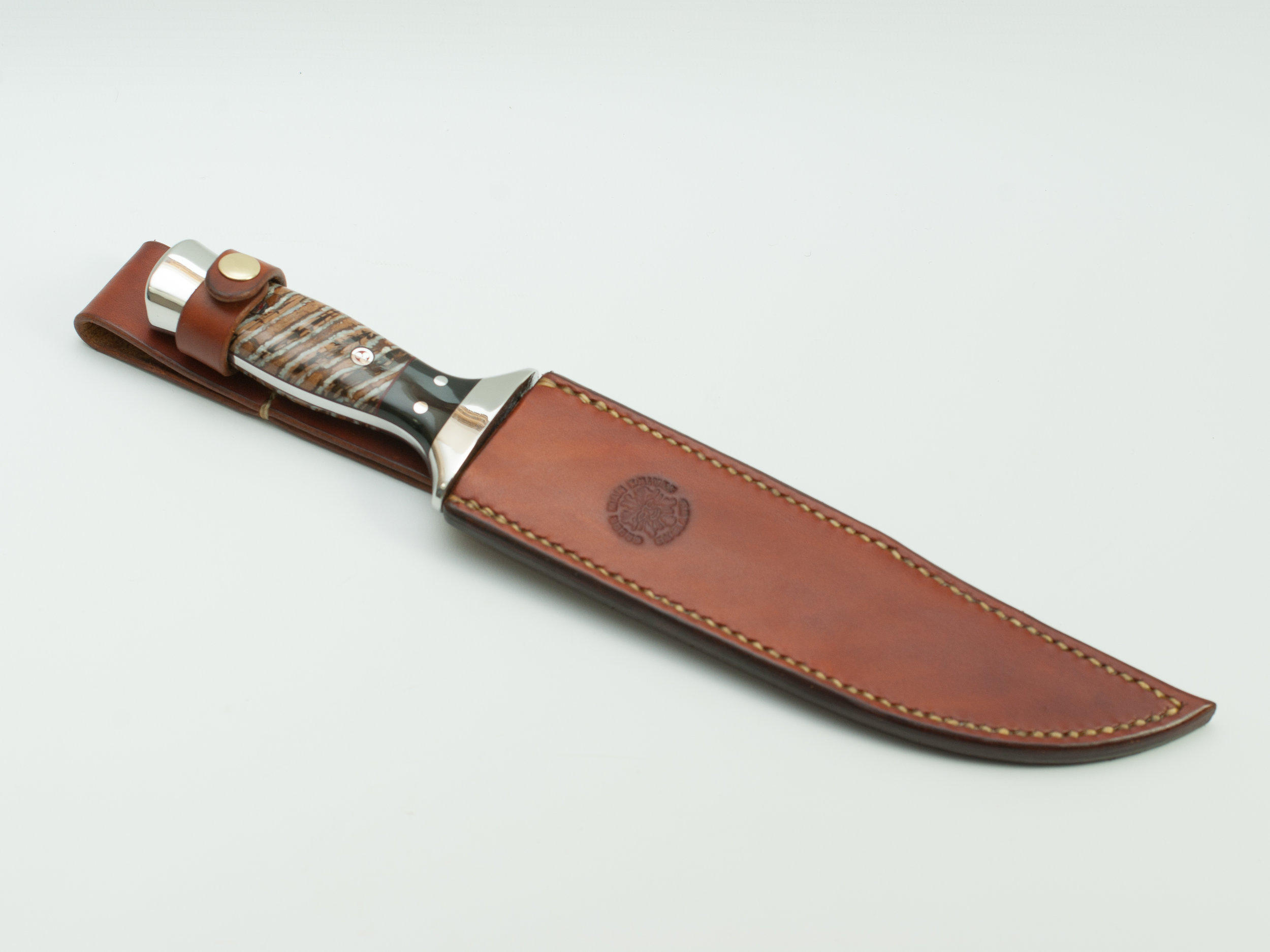 Marines Hunter in it's hand dyed and hand stitched sheath made from full grain, vegetable tanned, 8oz tooling shoulder - the best cow leather available.