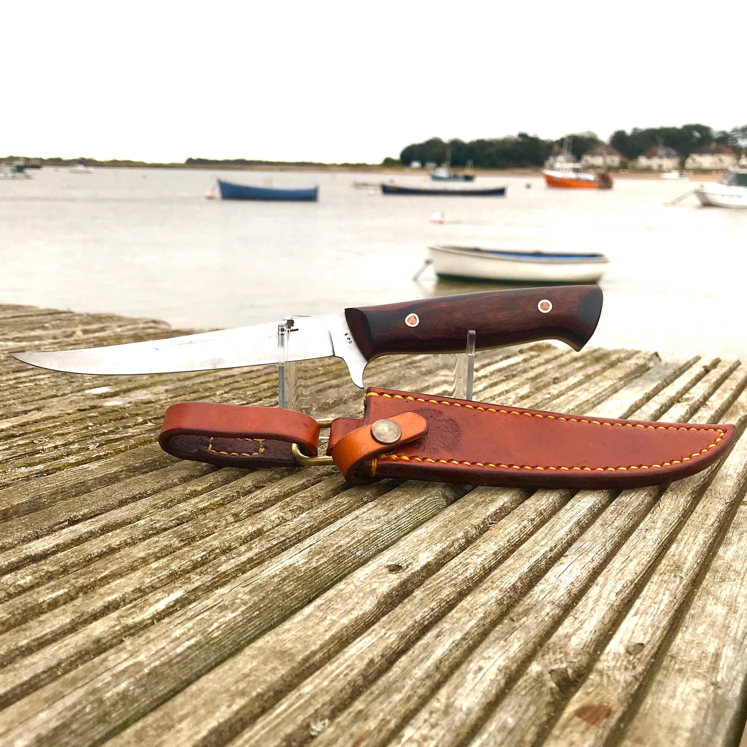 A Fishermans knife with its leather belt sheath hand made in the UK by Green Man Knives