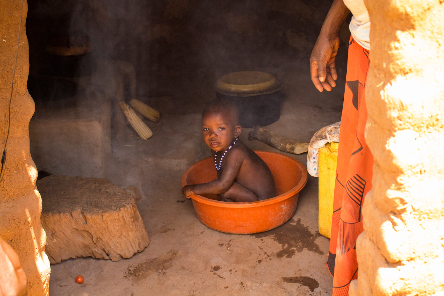 Young children are often in the kitchen with their mothers, since women spend many hours a day preparing food. Open-cooking fires are especially dangerous to children, since children can trip on logs, causing hot pots to spill on them, and smoke-inhalation can damage their lungs.