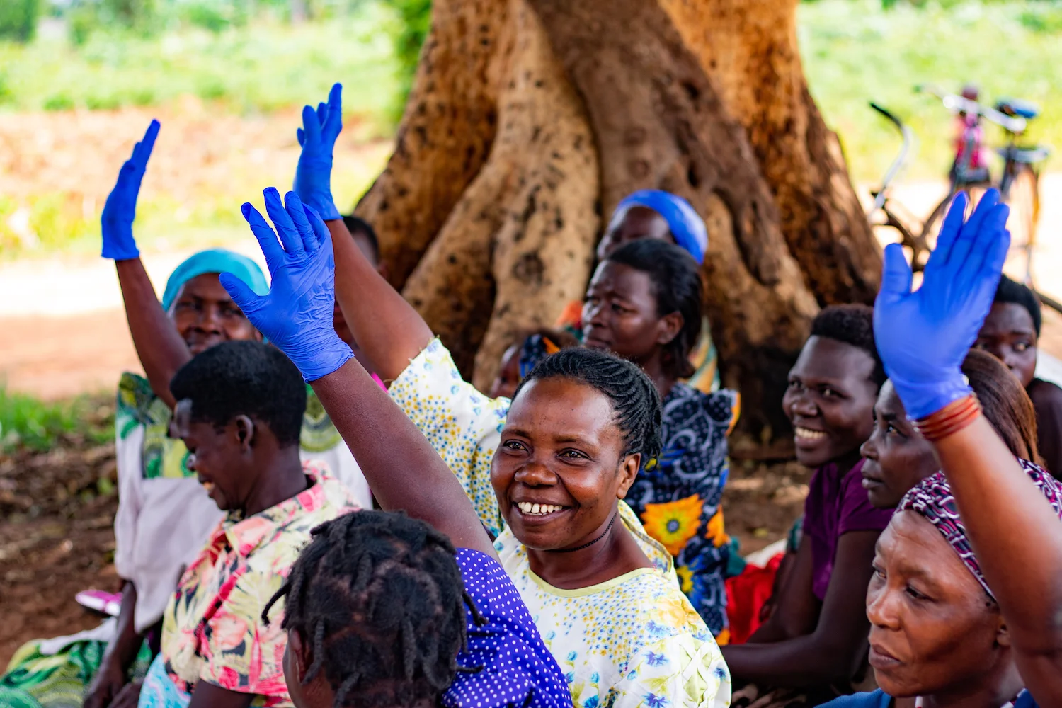 Lorna passed out gloves and asked community members to raise their hands if they thought they needed to wear gloves in a given instance when interacting with someone infected with HIV/AIDS. To shake someone’s hand, no. To touch their blood, yes.