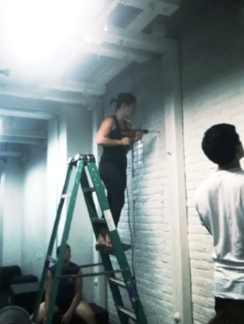Drilling holes for a new pull-up bar in the basement of the second CFCC space. 