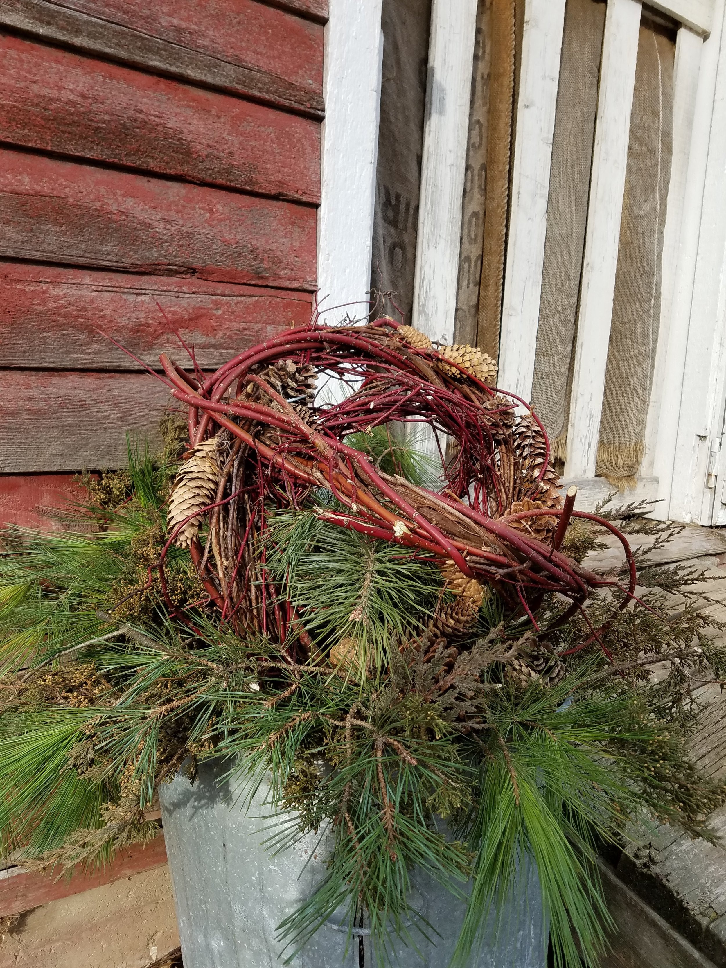 winter container with red twig ball