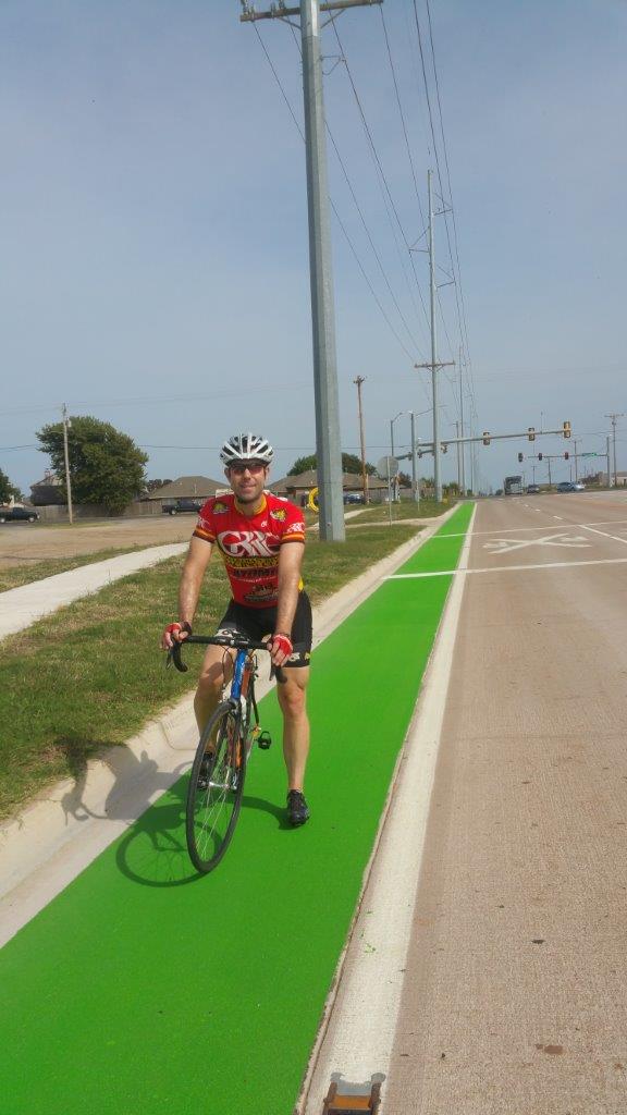 bicyclist on green bike lane