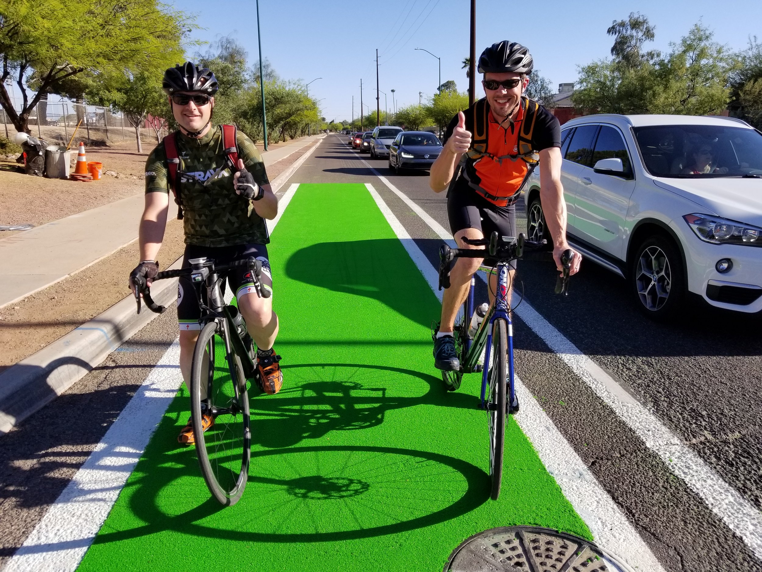 bicyclists on green bike lane