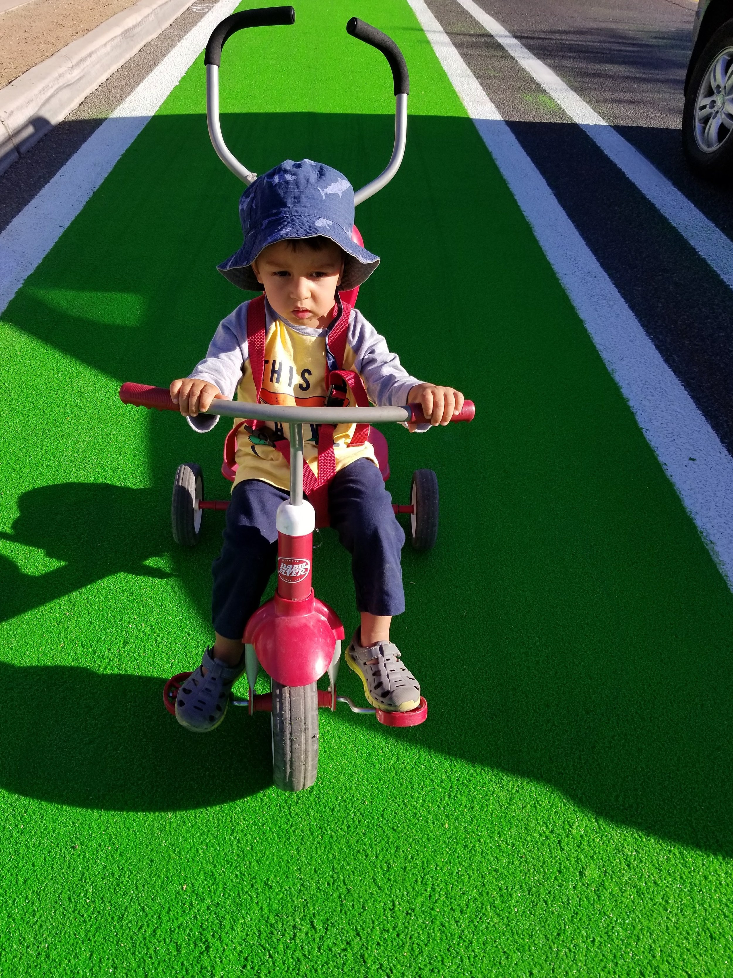 child on green bike lane