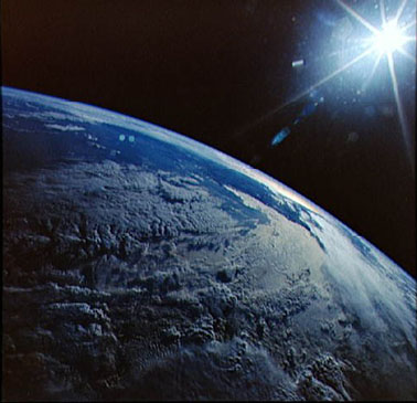 Earth and the Sun, as viewed by the Space Shuttle Discovery.