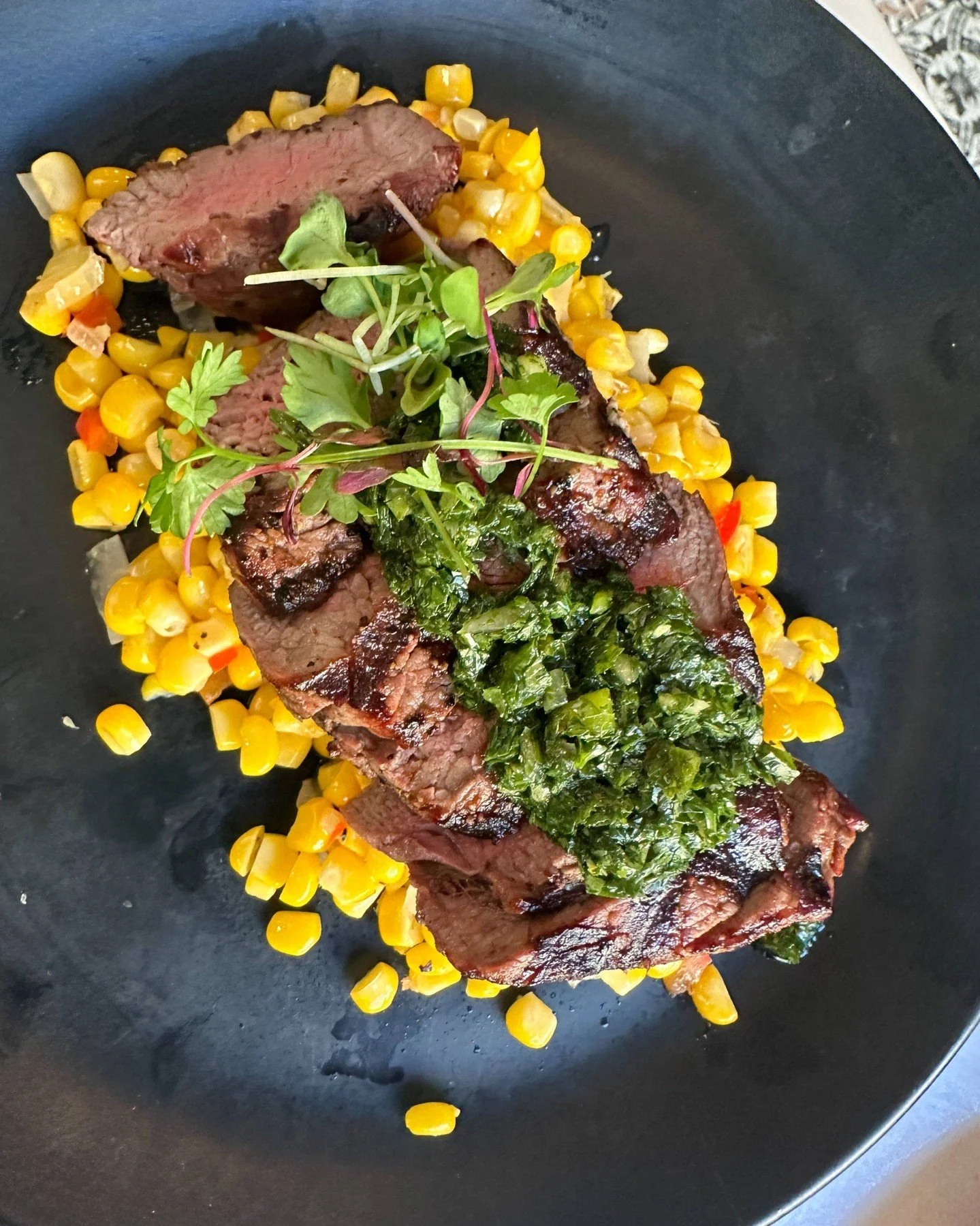 Don't feel like cooking tonight?  Come in for Grilled Beef Tenderloin with Roasted Corn and Aji Chimichurri! #DinnerDelight